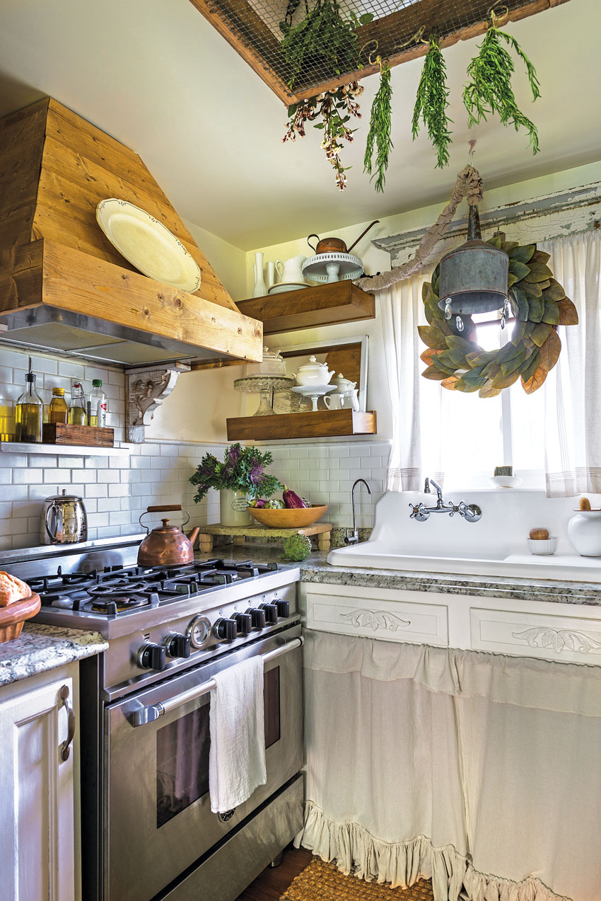 a custom-made hood and a farmhouse sink in small charming cottage kitchen