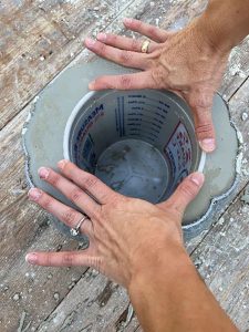 Bucket is pressed into the cement pumpkin filling to create a hollow middle where flowers can be put once dry.