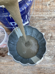 Cement is poured into the cement pumpkin bowl cast.