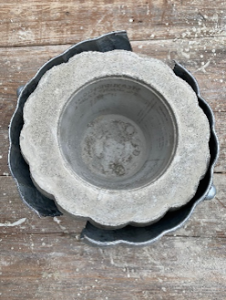 Hollow cement pumpkin bowl is ready to be taken out of the mold.