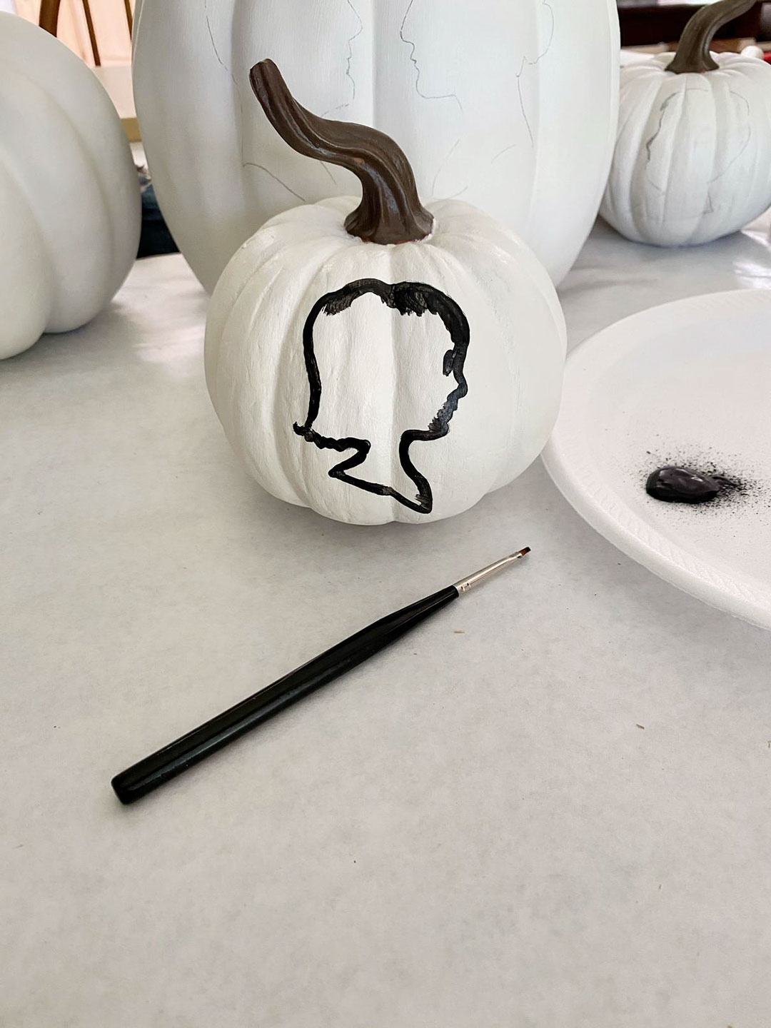 Profile portrait outline on pumpkin 