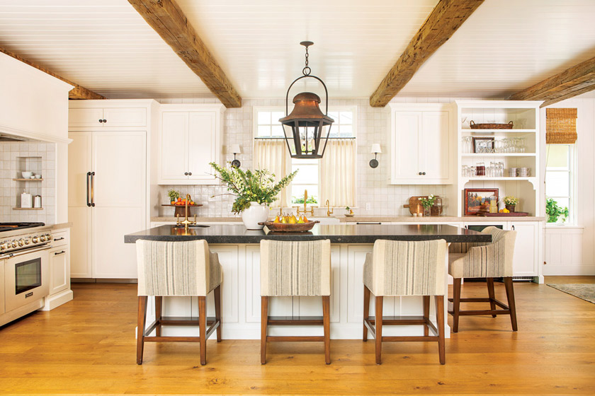 limestone slab countertops and Belgian Zellige backsplash tiles.