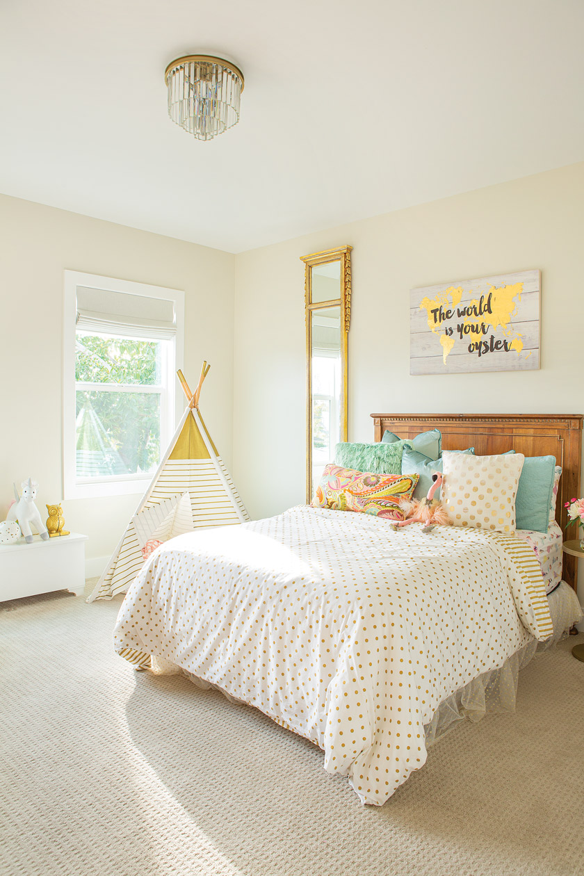 childs bedroom in white, yellow and light blue with a teepee in corner