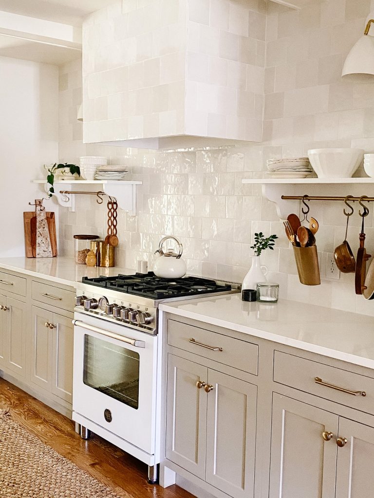 Not everyone likes a white kitchen, and these lower cabinets are the perfect neutral greige. 