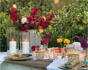 we set up this DIY Farmhouse table in the middle of our garden and strung tons of lights above for ambience and cozy vibes.