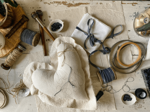 Rosana Milam's workspace, including her threads, fabrics, and tools