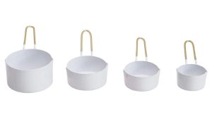 White and brass measuring cups