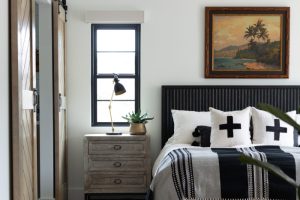 Black and white bed set with oak sliding doors and beach painting