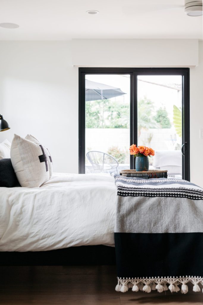 Black and white bedroom with view of patio