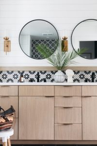 Black and white bathroom with tan cabinets