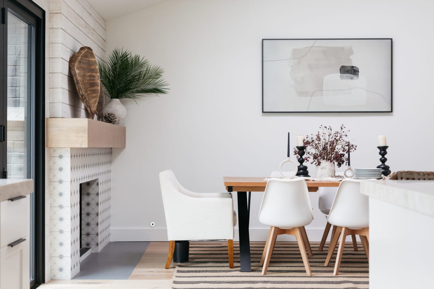 Black, white, and tan dining area that includes a fireplace