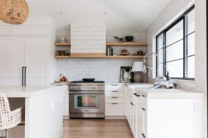 White kitchen with off-white backsplash and black hardware