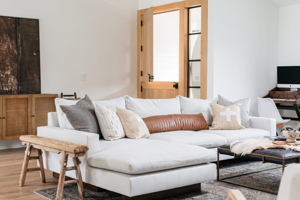 Living room with white couch and oak Dutch front door