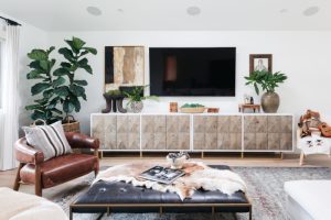 Modern beach home living room with leather seats and boho beach details
