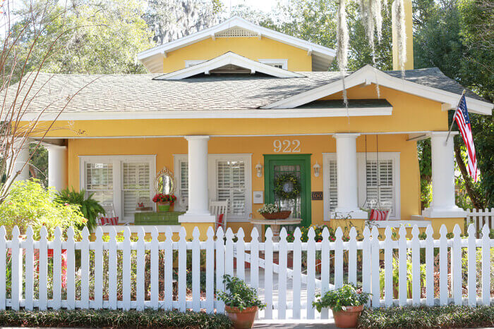 Home with a bright yellow exterior and white trim