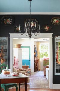 Black chalkboard wall and a brass chandelier