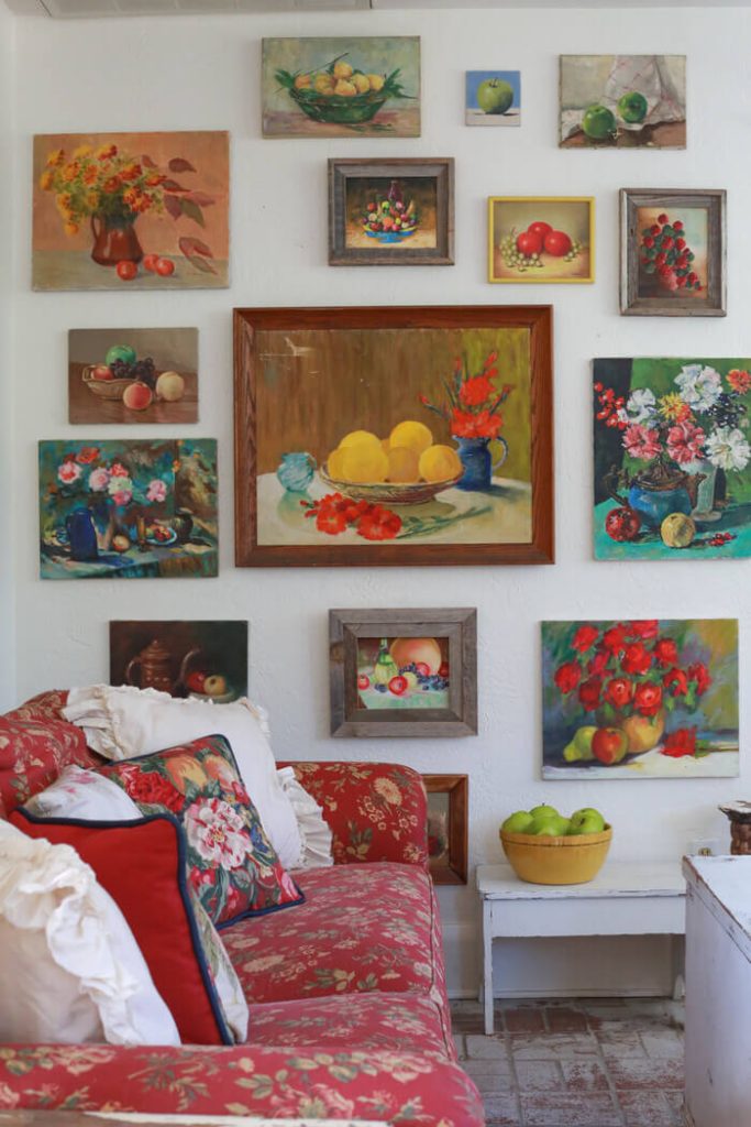 A wall with paintings of fruits and flowers