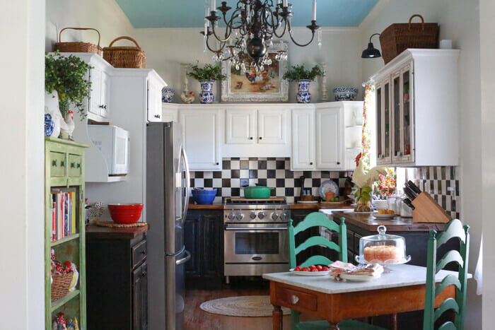 A kitchen with black and white cabinets and a black and white checkered backsplash