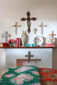 Religious artifacts above a mantel in a bedroom