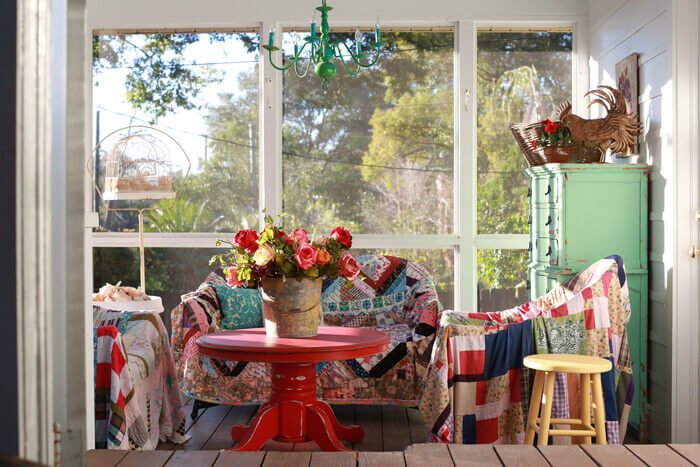 Wicker furniture under thrift store quilts