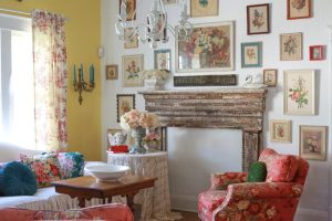 Fireplace mantel surrounded by framed vintage botanicals on the wall