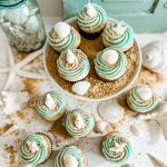 Beach inspired cupcakes decorated with brown sugar sand and sea shells