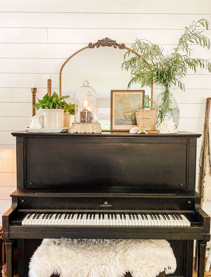 Piano topped with beachside décor, like shells and wicker details