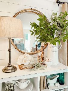 Blue glass and ceramic details on a beach inspired bookshelf