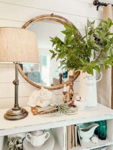 Blue glass and ceramic details on a beach inspired bookshelf