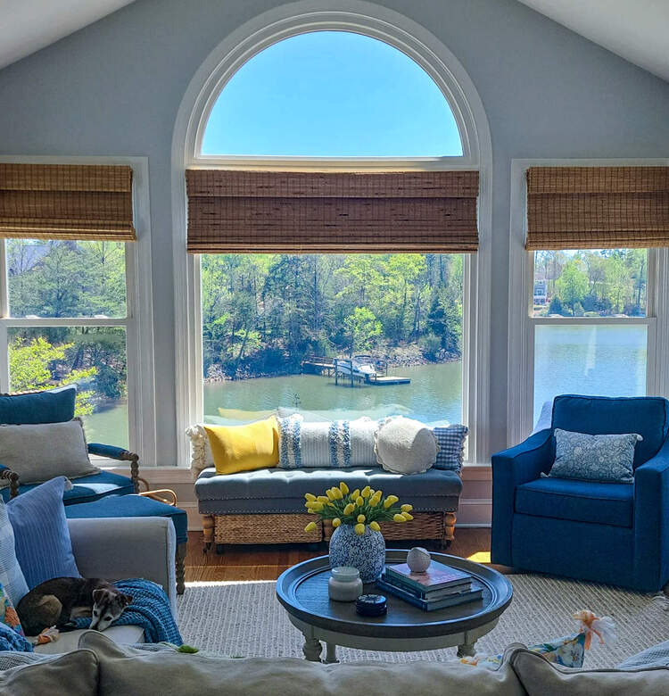 Lakefront view with large windows and coastal design with yellow accents