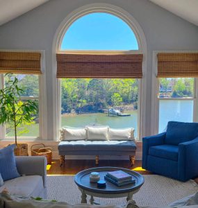 Lakefront view with large windows and coastal design