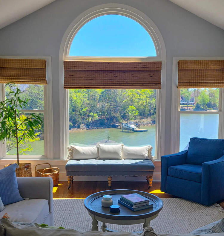 Lakefront view with large windows and coastal design