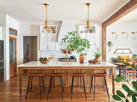 white and oak kitchen with large island and clear lighting fixtures