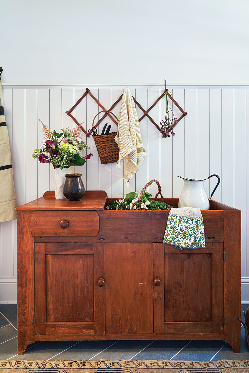 entryway with beadboard and herringbone patterned tile