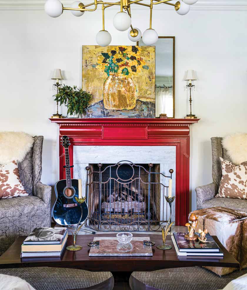 red mantel with modern painting in living room of colorful historic home