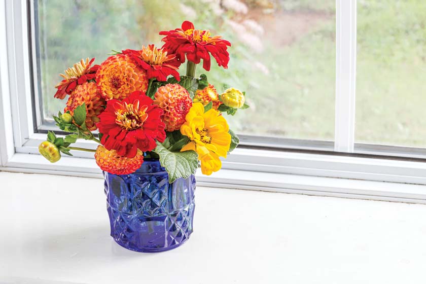 blue vintage style vase with fall red and yellow flowers