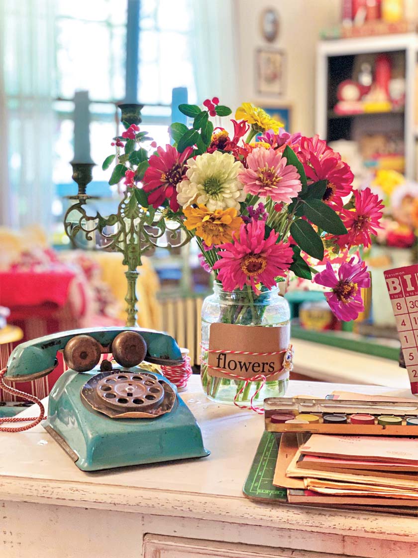 zinnias in a mason jar for a fall vignette