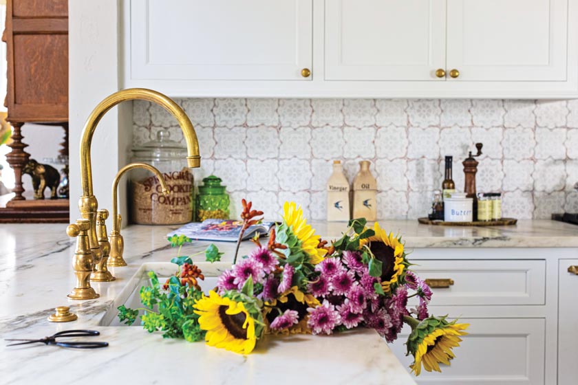 hand-painted backsplash tile and patina faucet in remodeled kitchen