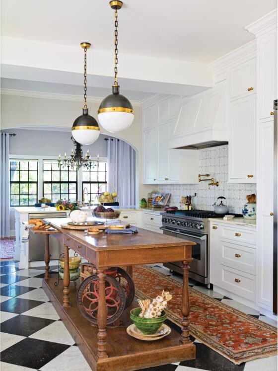 antique wood island and black and white checkered tile floor in remodeled island
