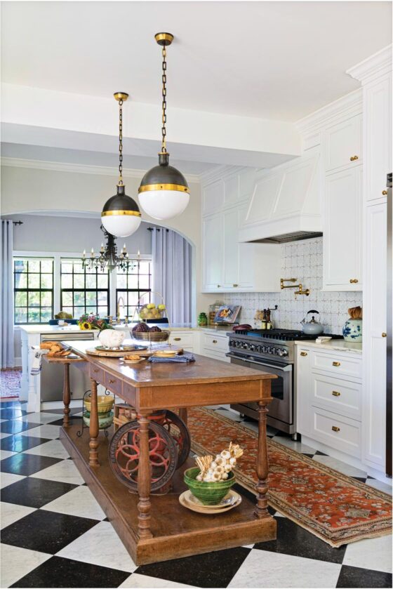 antique wood island and black and white checkered tile floor in remodeled island