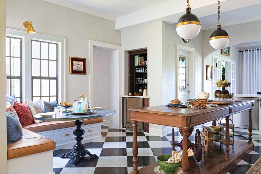 wood island and round zinc table in remodeled Spanish Mediterranean style kitchen