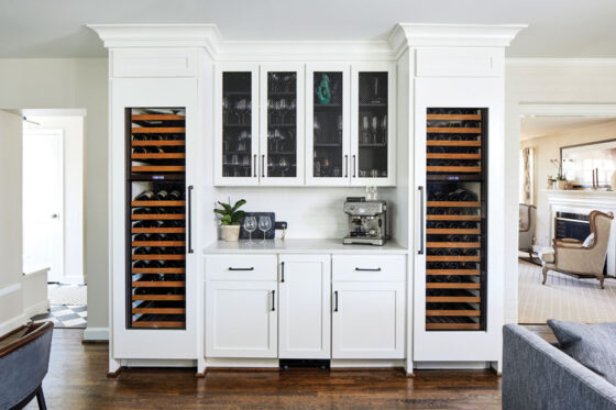 white cabinetry and built in shelves for wine storage