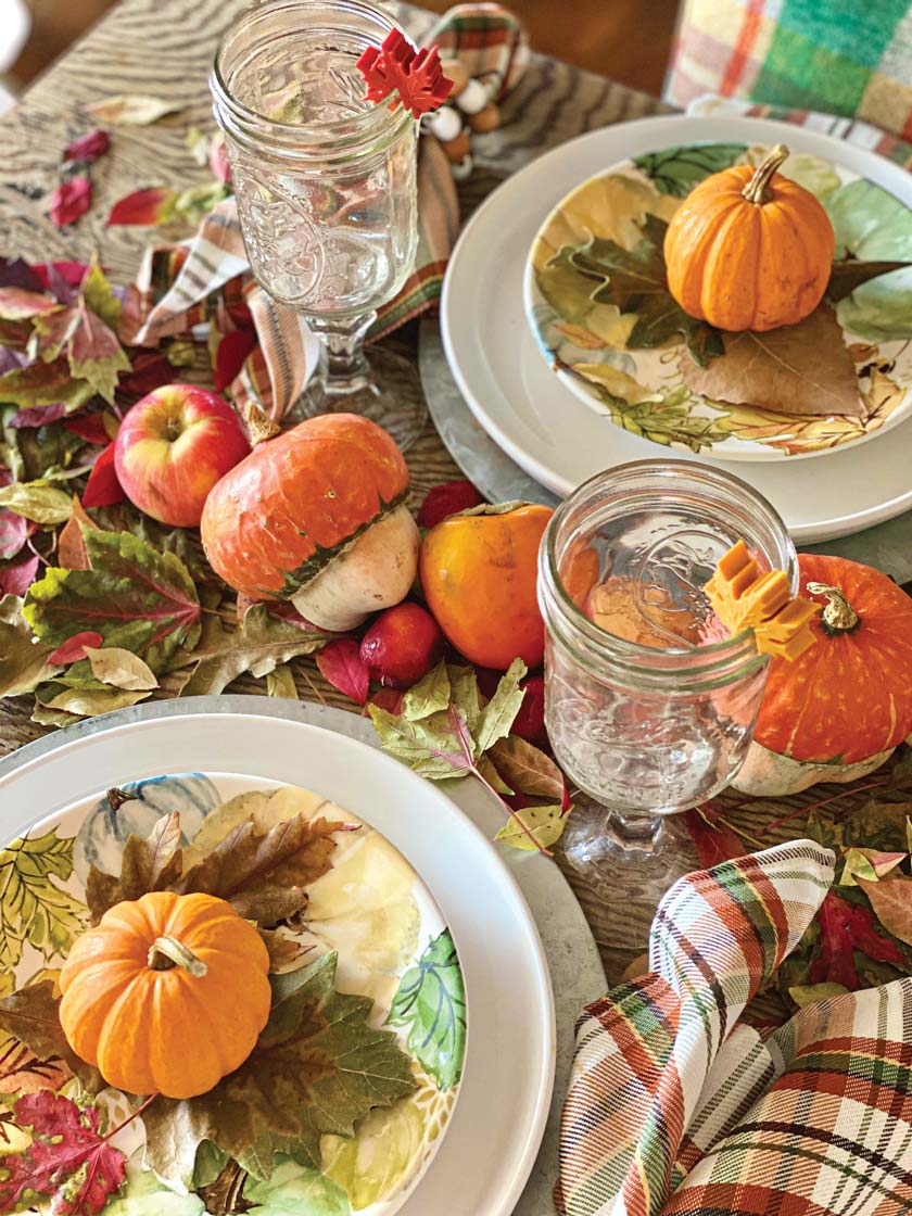 farmers market fall tablesetting with small pumpkins in each place setting