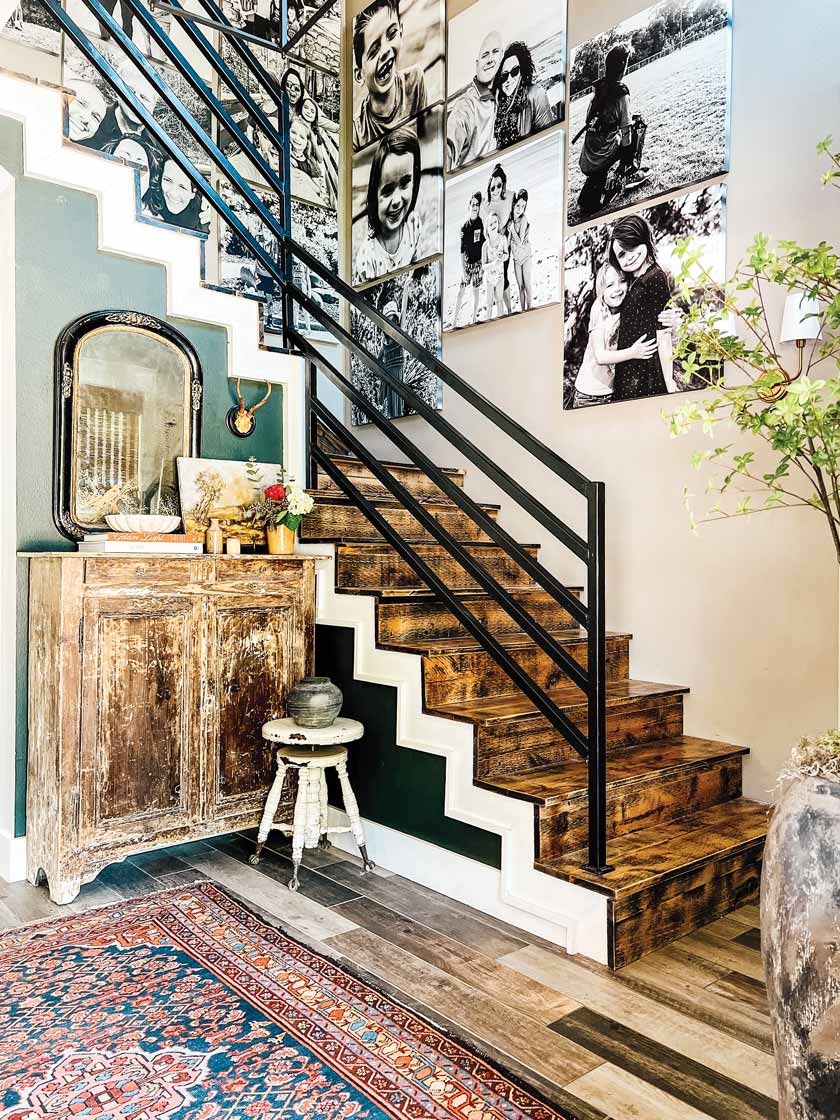 photo collage on stairway in Texas home with antique furniture at bottom of staircase