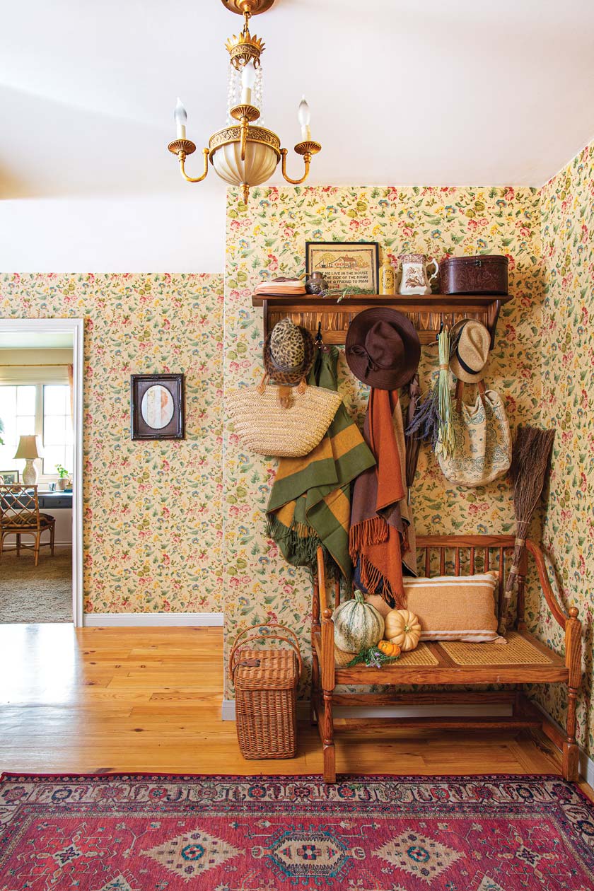 floral wallpaper and traditional rug in entryway of maximum style cottage home