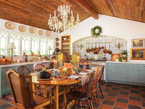 wide angle view of kitchen with chandelier and tiled backsplash in maximum style California home