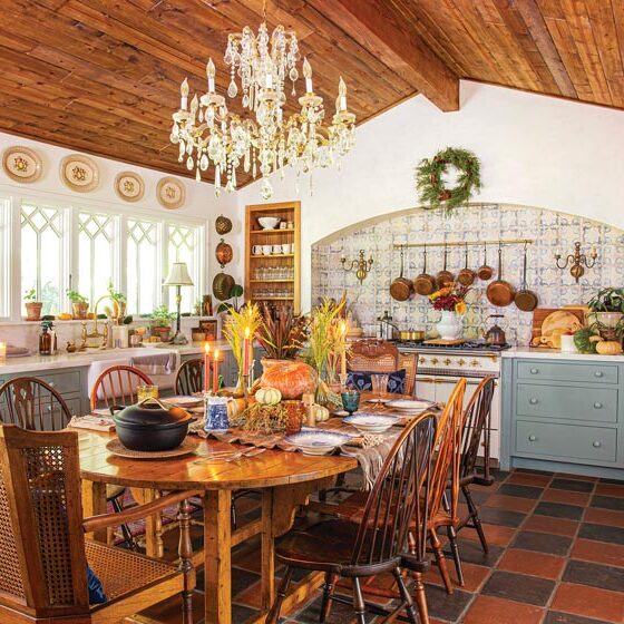 wide angle view of kitchen with chandelier and tiled backsplash in maximum style California home