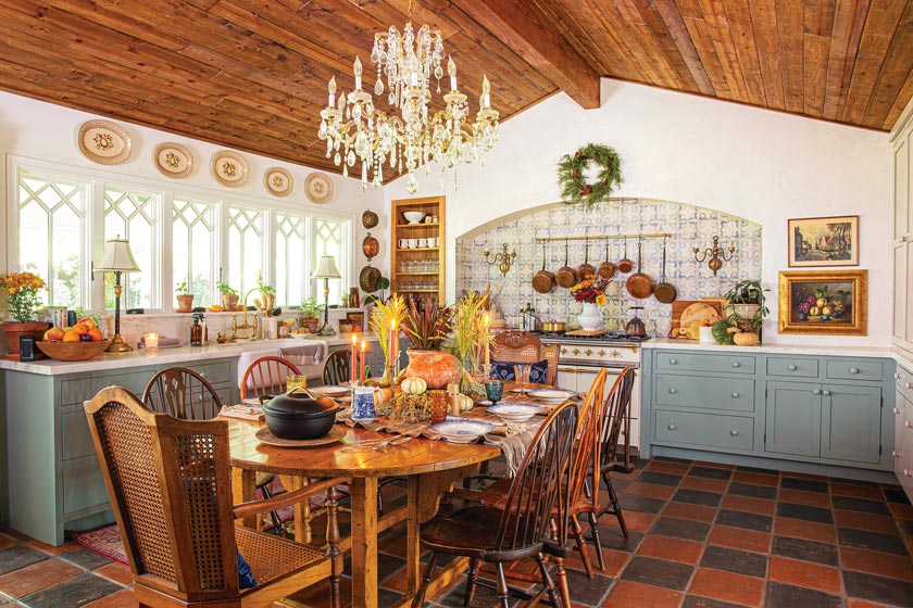 wide angle view of kitchen with chandelier and tiled backsplash in maximum style California home