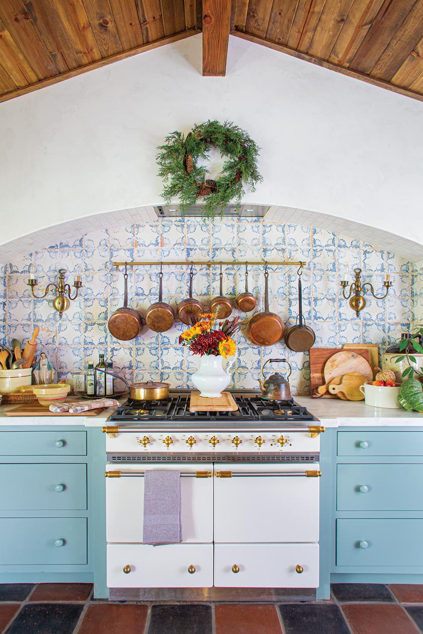 exposed wood beam ceiling and tiled backsplash and powder blue cabinetry in renovated California kitchen