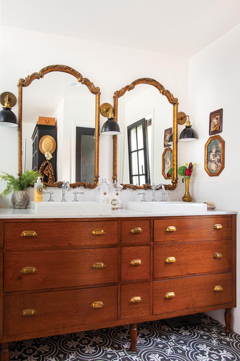 bathroom with patterned tile and double sink